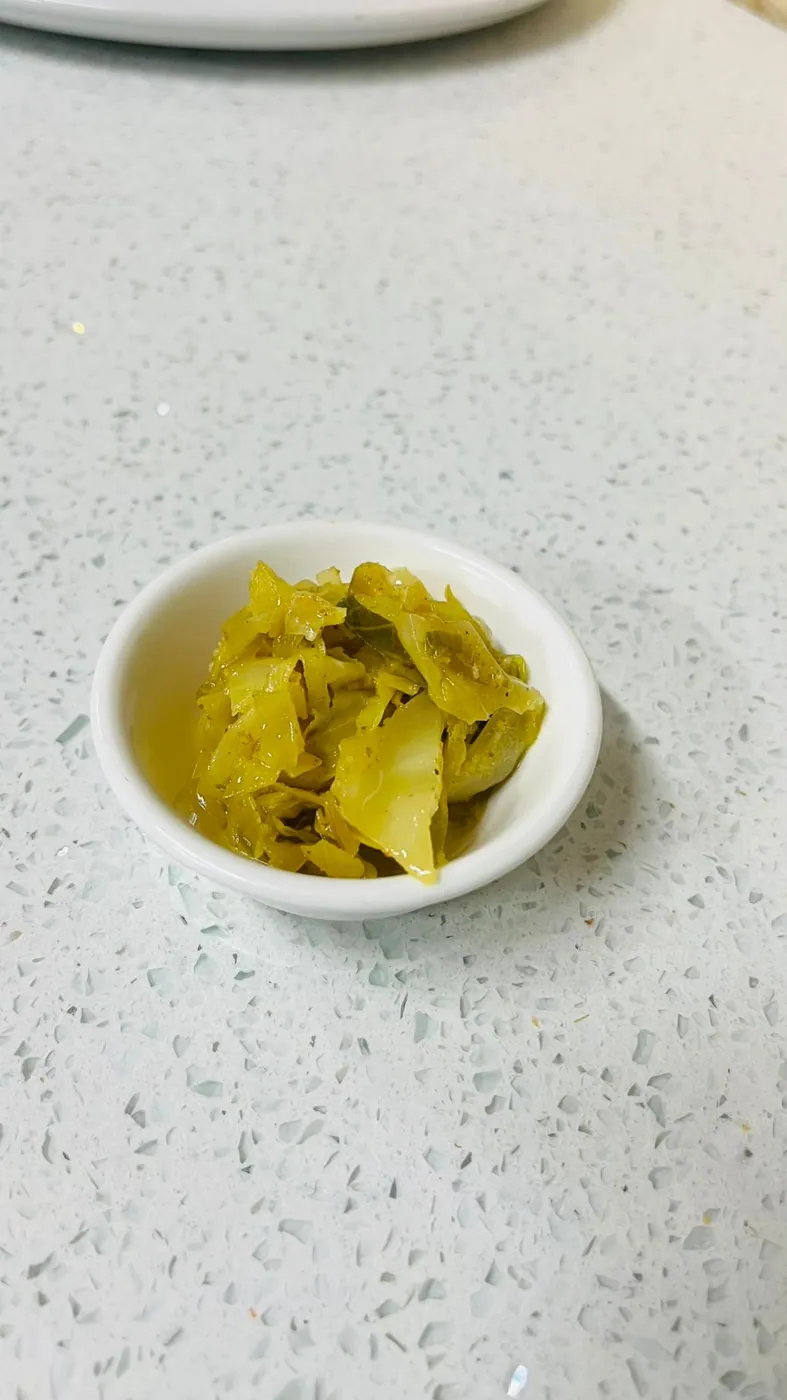 Curried cabbage side in a small bowl