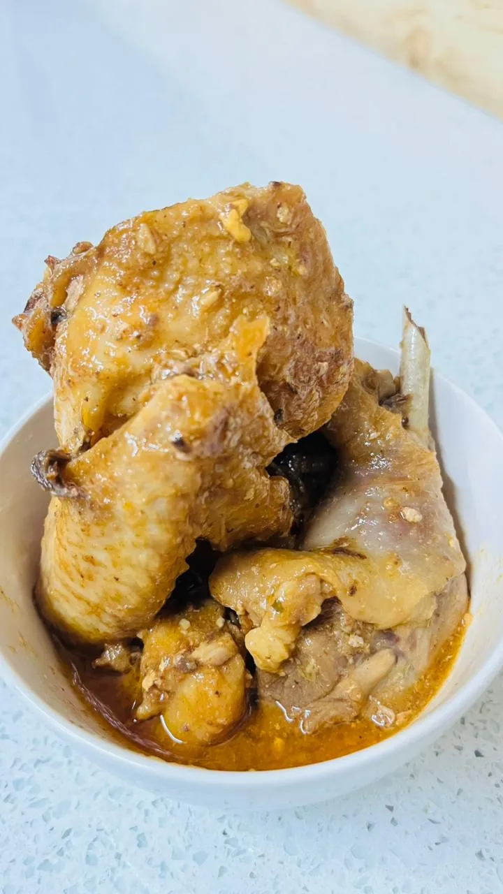 Basted chicken pieces in a white bowl