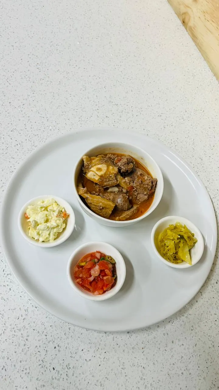 Mogodu platter with three side bowls on a white plate