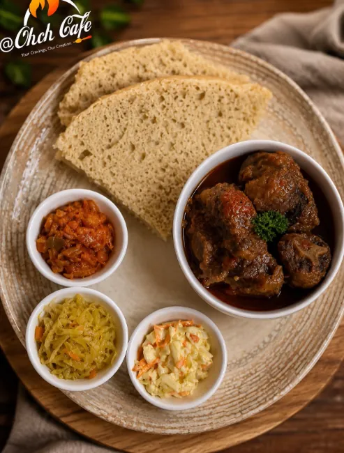Traditional African plate with steamed bread, braised stew, chakalaka, atchar and curried slaw