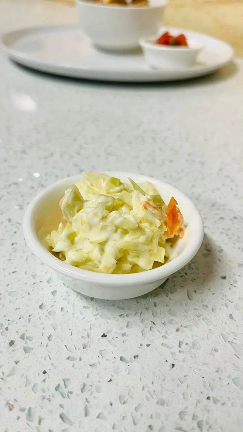 Creamy coleslaw side in a small bowl